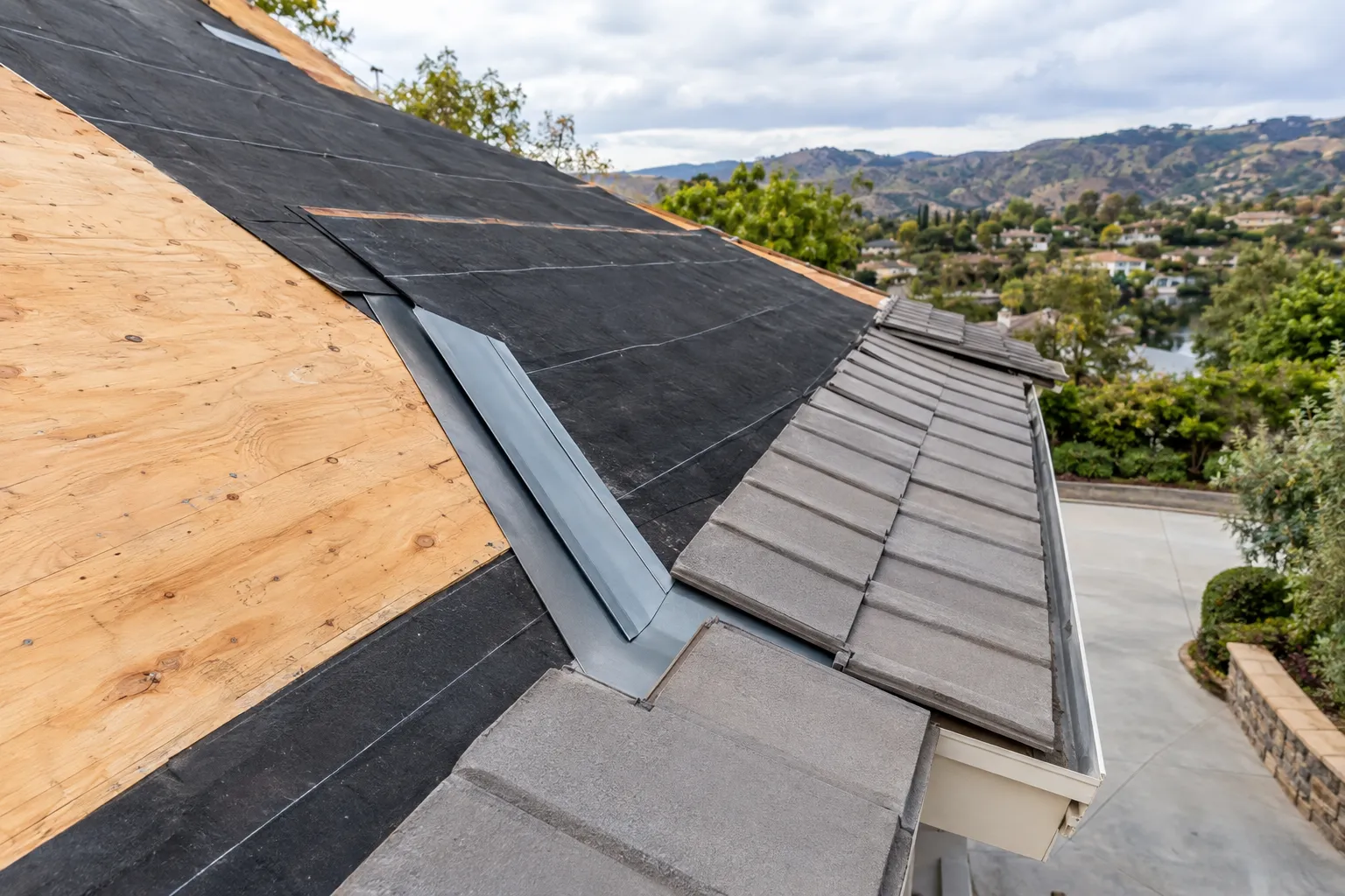 Steep roof replacement showing underlayment and valley flashing in Westlake Village, California