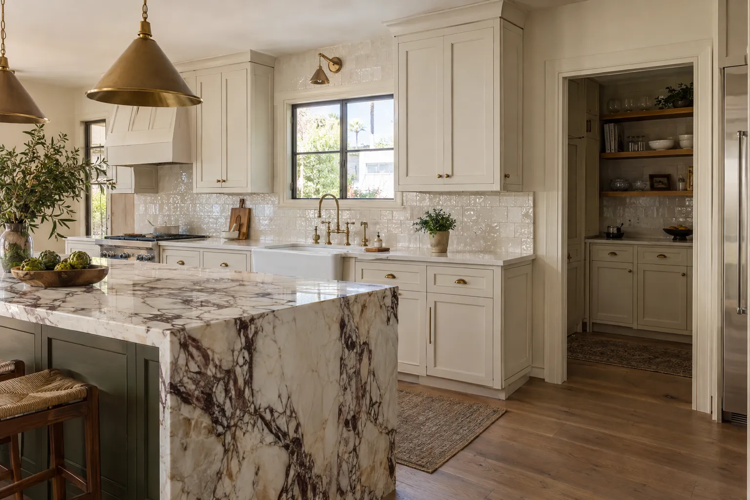 Custom shaker cabinetry, marble waterfall island, and butler's pantry in a West Hollywood, California kitchen remodel